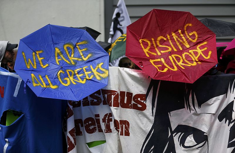 Protesters hold umbrellas with slogans written on it during an anti-capitalism "Blockupy" demonstration in Frankfur