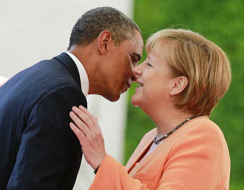 U.S. President Obama embraces German Chancellor Merkel outside the Chancellery in Berlin