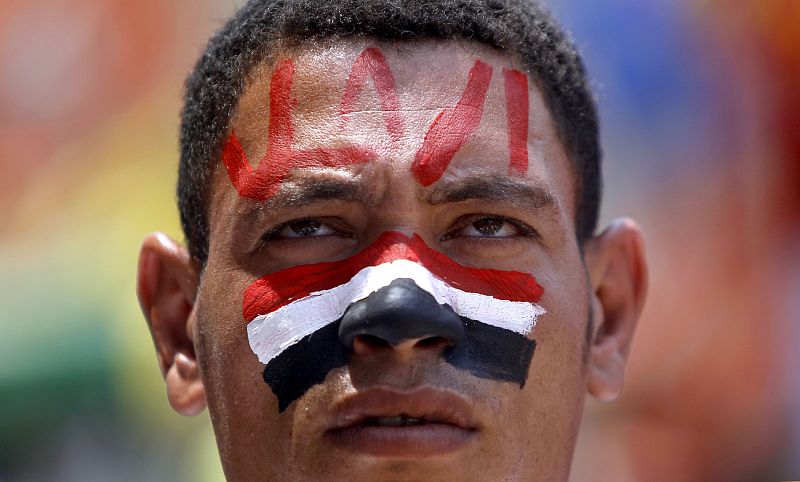 A protester opposing Egyptian President Mohamed Mursi with the national flag painted on his face reading "Leave" attends a protest at Tahrir square