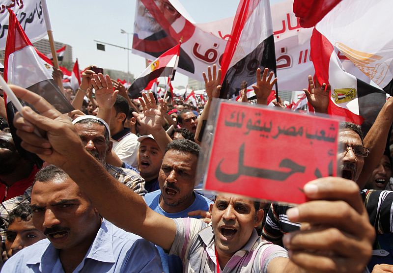 Protesters opposing Egyptian President Mursi shout slogans against him and brotherhood members during protest at Tahrir square in Cairo