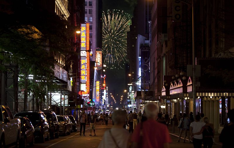 People stand in the middle of 44th St at Times Square to watch Independence Day fireworks in New York