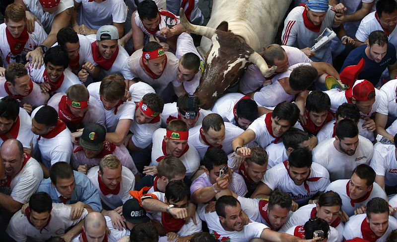 A steer tries to get through a crowd of runners at the San Fermin festival in Pamplona