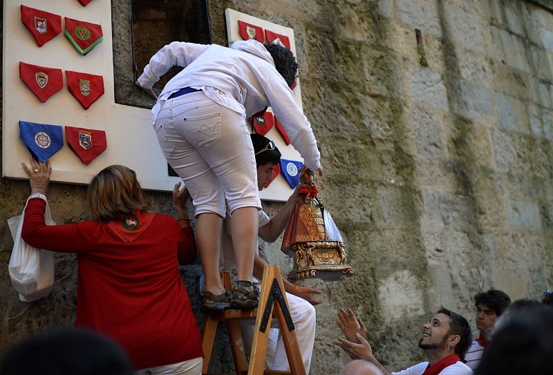 A statue of San Fermin is lifted into niche on Santo Domingo hill before running of the bulls at the San Fermin festival in Pamplona