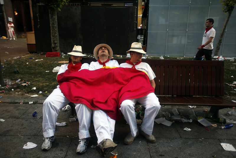 Revellers sleep on the street before the first running of the bulls of the San Fermin festival in Pamplona