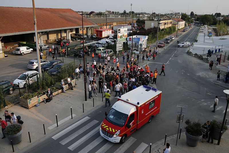 Firefighters are and rescue forces are seen next to the site of an intercity train accident at the Bretigny-sur-Orge station near Paris