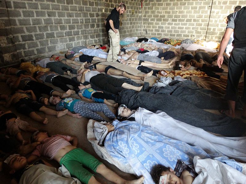 Relatives and activists inspect the bodies of people they say were killed by nerve gas in the Ghouta region, in the Duma neighbourhood of Damascus