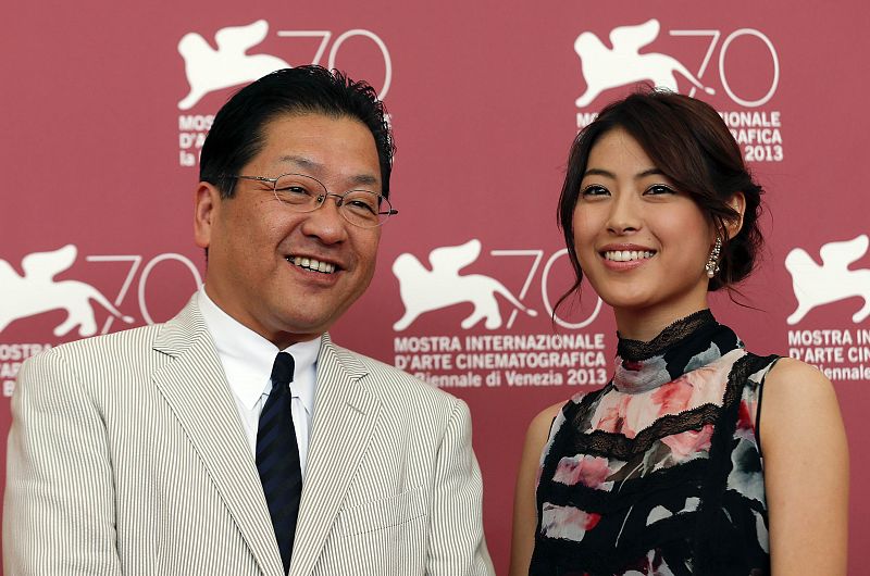 Actress Takimoto, who voiced the role of Naoko Satomi on animated feature film "Kaze Tachinu", poses with Hoshino, president of Studio Ghibli, during a photocall at the 70th Venice Film Festival
