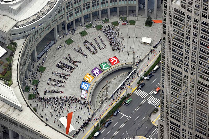 An aerial view shows people sitting in formation to the words "thank you" and displaying signs that collectively read "Arigato" during an event celebrating Tokyo being chosen to host the 2020 Olympic Games, in Tokyo