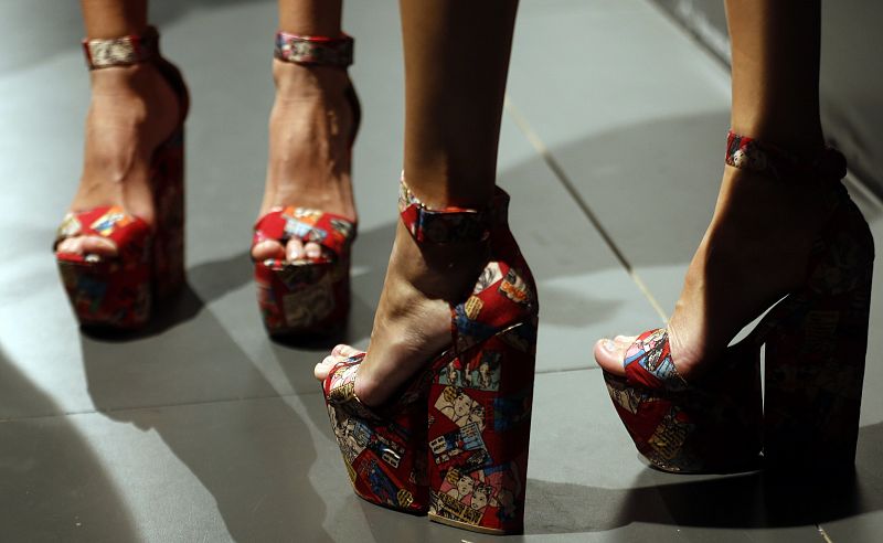 Models wear shoes created by designer Sarda during the Mercedes-Benz Fashion Week in Madrid