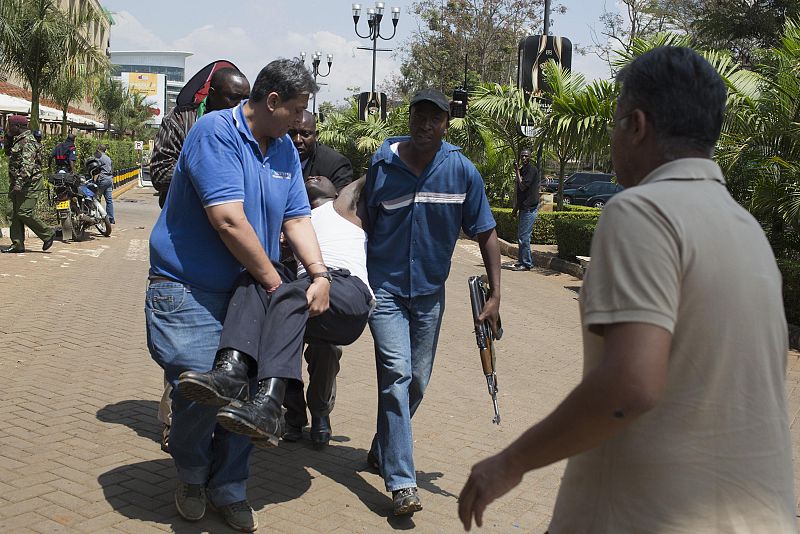 An injured man is carried out of Westgate Shopping Centre where gunmen went on a shooting spree, in Nairobi