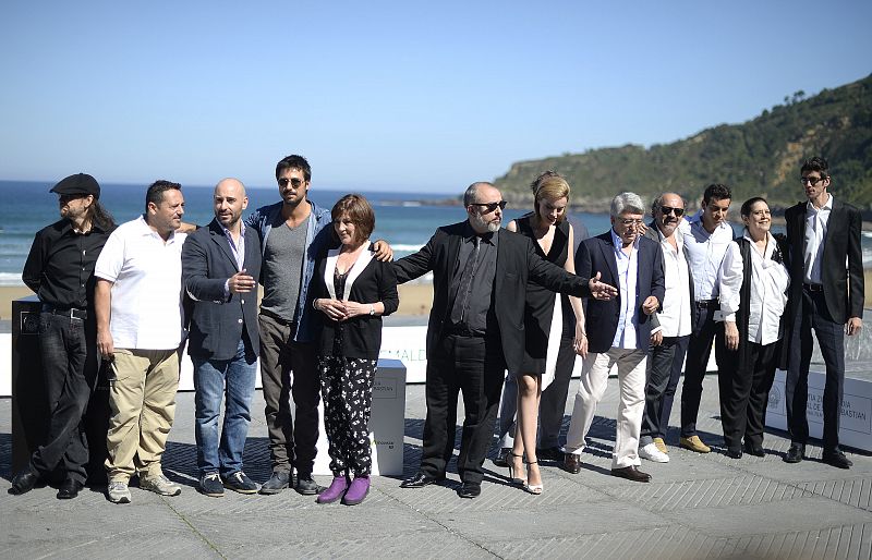 Spanish film director Alex de la Iglesia poses with cast members and producers during a photocall at the San Sebastian Film Festival