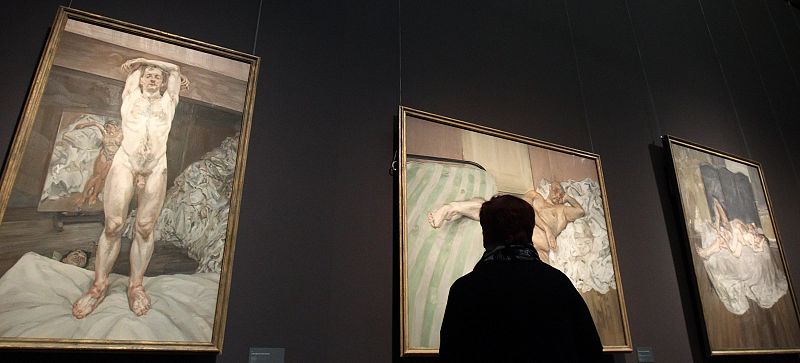 Visitor looks at paintings by British painter Freud during a preview of an exhibition at Kunsthistorisches Museum in Vienna