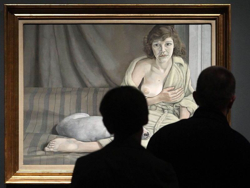 Visitors look at painting by British painter Freud during preview of exhibition at Kunsthistorisches Museum in Vienna