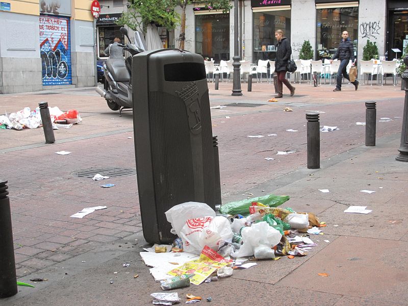 Basura en la calle Pez tirada en el suelo junto a una papelera