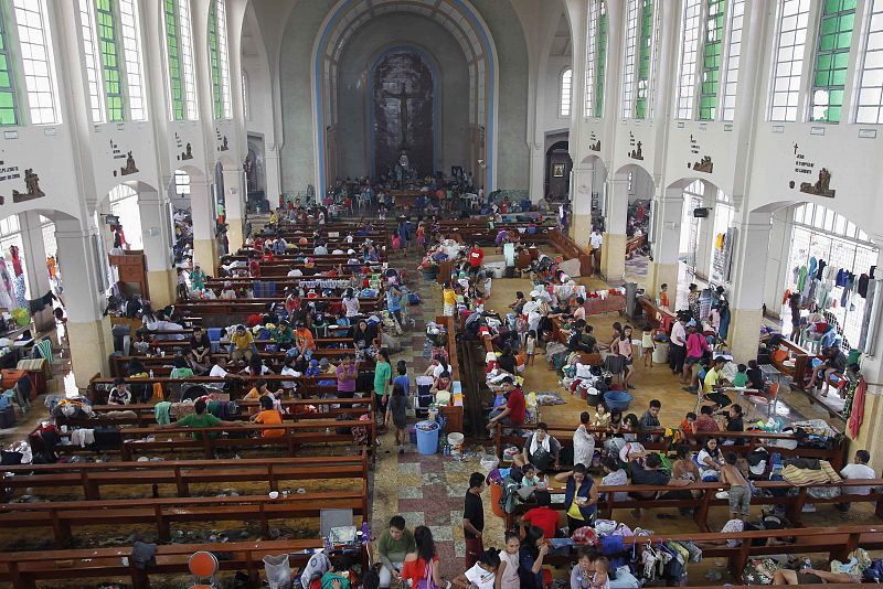 Residents seek refuge inside Catholic church which converted into evacuation center after super Typhoon Haiyan battered Tacloban city