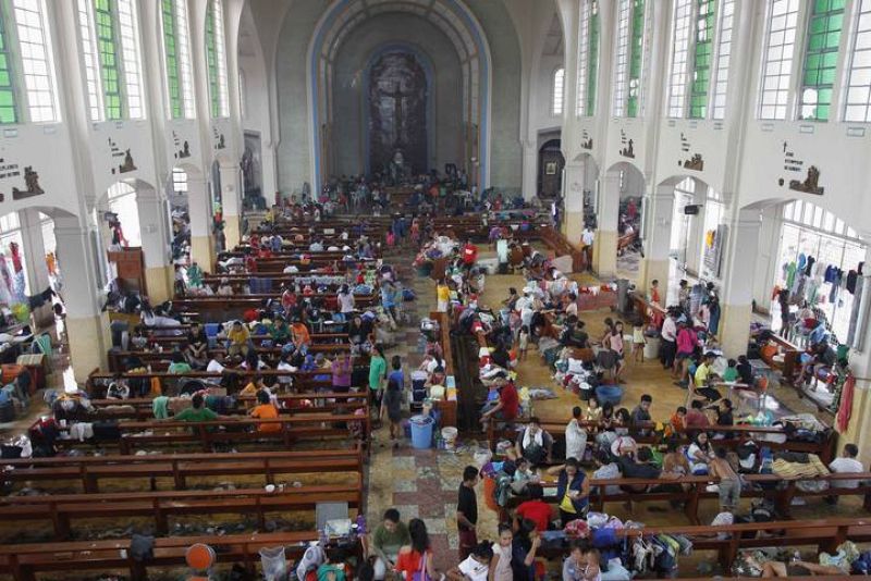 Residents seek refuge inside Catholic church which converted into evacuation center after super Typhoon Haiyan battered Tacloban city