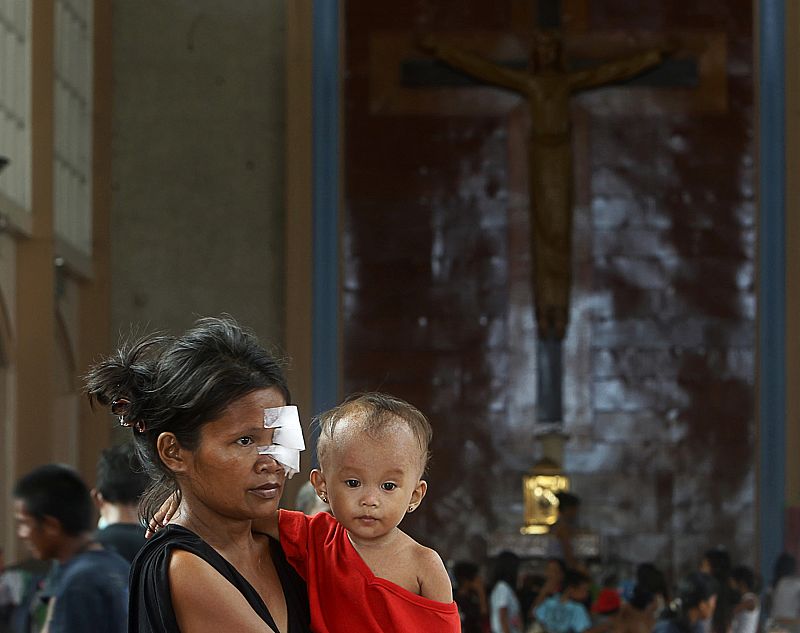 Una madre herida junto a su hijo en la iglesia usada como improvisado refugio. La cifra de heridos asciende a 2.623.