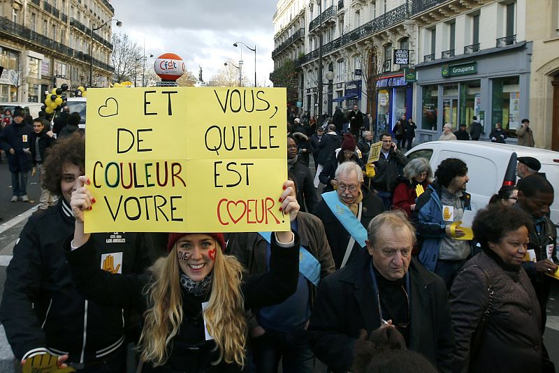 A woman with a message on her face reads "Love" as she attends a protest march called "The March for Equality and Against Racism" in Paris
