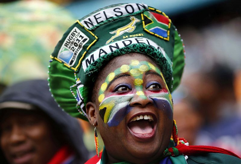 People start singing as they arrive for a mass memorial for Nelson Mandela in Johannesburg