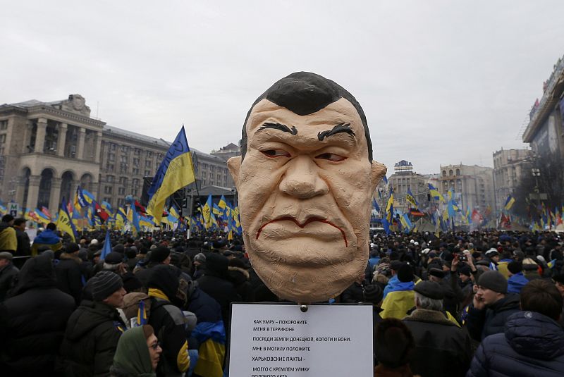 Pro-European integration protesters hold an effigy of Ukranian President Yanukovich during a rally in Independence Square in Kiev