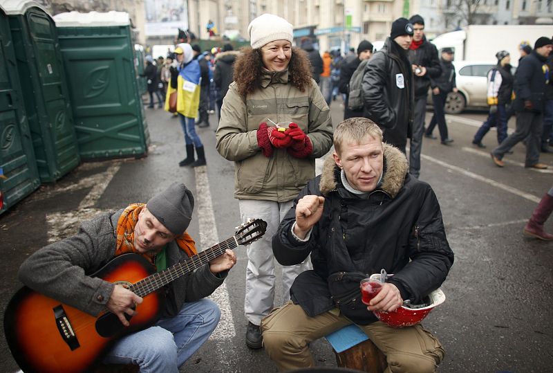 Pro-European intergration protesters play music during a mass rally at Independence Square in Kiev