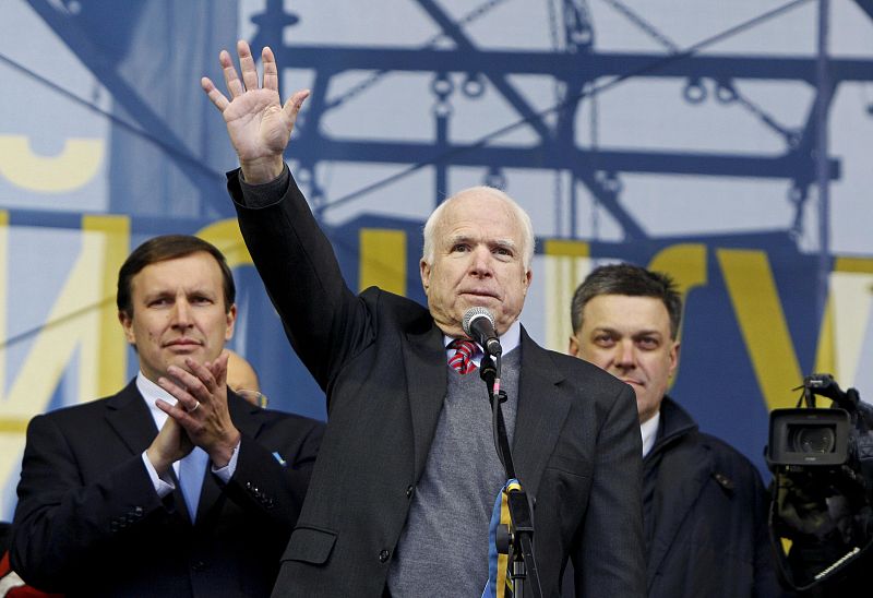 U.S. Senator McCain waves to pro-European intergration protesters during a mass rally at Independence Square in Kiev