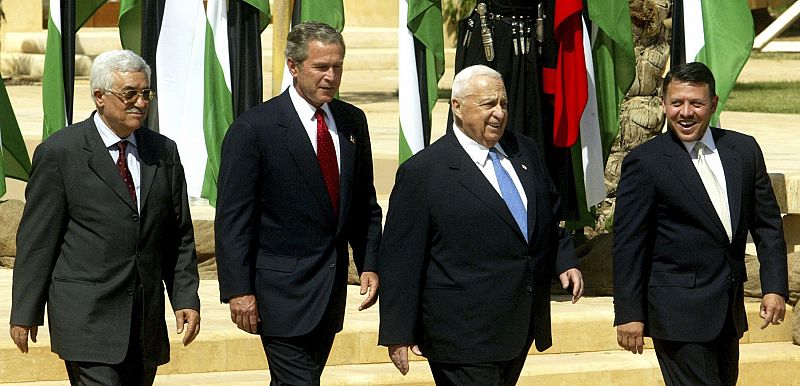 File photo of Palestinian Prime Minister Abbas, U.S. President Bush, Israeli Prime Minister Sharon and Jordan's King Abdullah II  walking to the podium for their final statement in Jordan