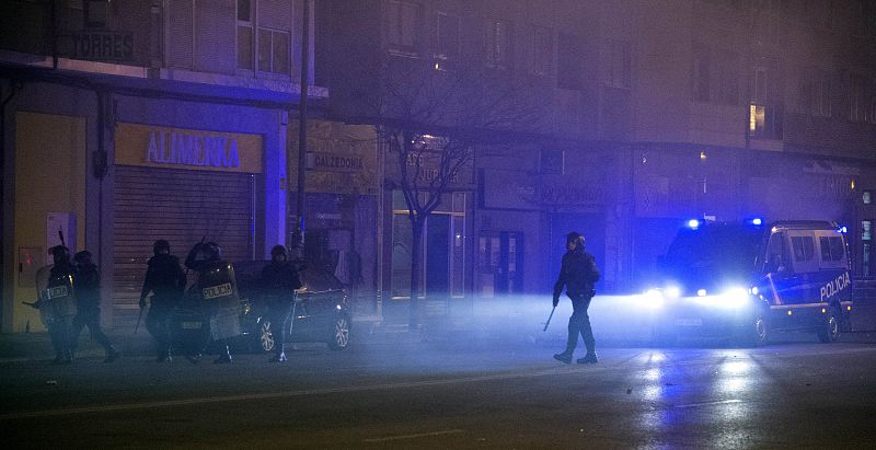 Riot police walk during a demonstration against construction plans to turn the Vitoria main avenue into a boulevard in Burgos