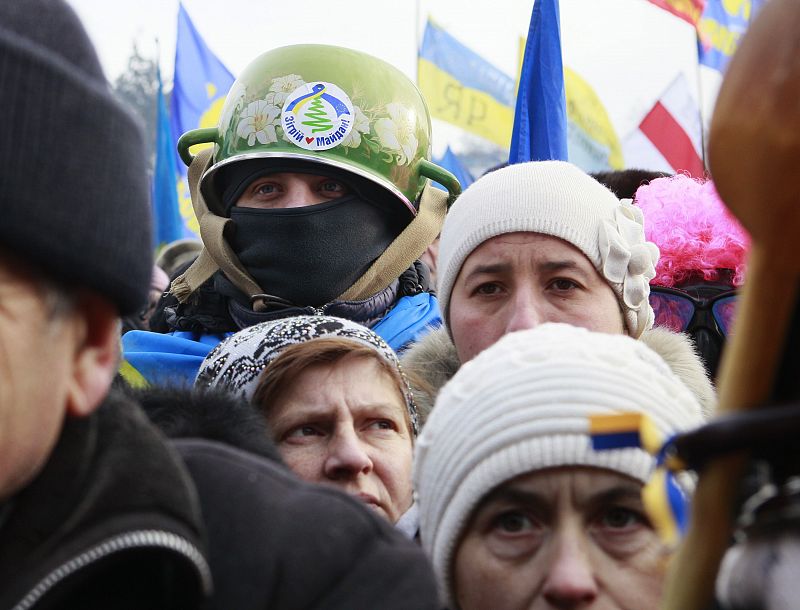 Pro-European integration protestors look on during a rally at Independence Square in Kiev