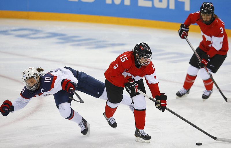 Team USA's Duggan falls to ice after hitting Canada's Daoust during the second period of their women's preliminary round hockey game at the Sochi 2014 Winter Olympic Games