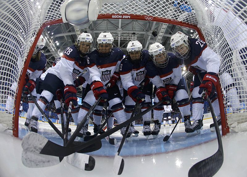 Team USA women's ice hockey players gather by the net before their game against Canada at the 2014 Sochi Winter Olympics