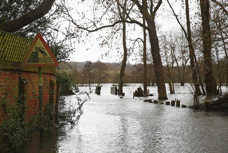 A danger sign is seen as water from the Thames River floods the village of Medmenham