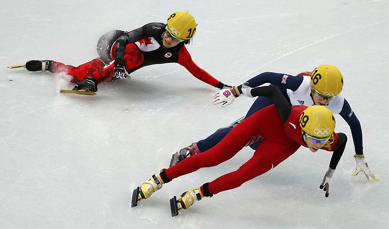 Canada's Hewitt crashes out behind China's Fan and Britain's Christie during the women's 500 metres short track speed skating quarter-final event at the Iceberg Skating Palace during the 2014 Sochi Winter Olympics