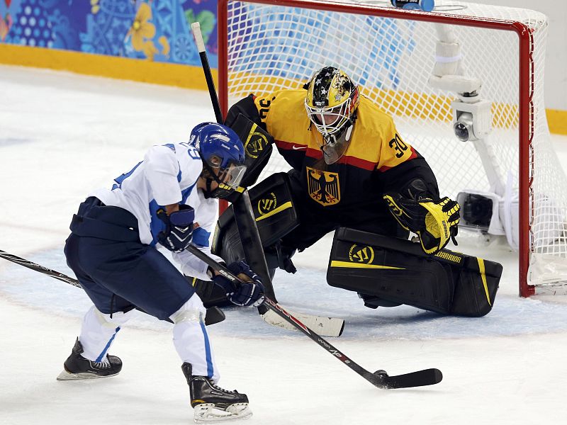 Germany's goalie Jennifer Harss makes a save against Finland's Karoliina Rantamaki during their women's ice hockey game at the 2014 Sochi Winter Olympics