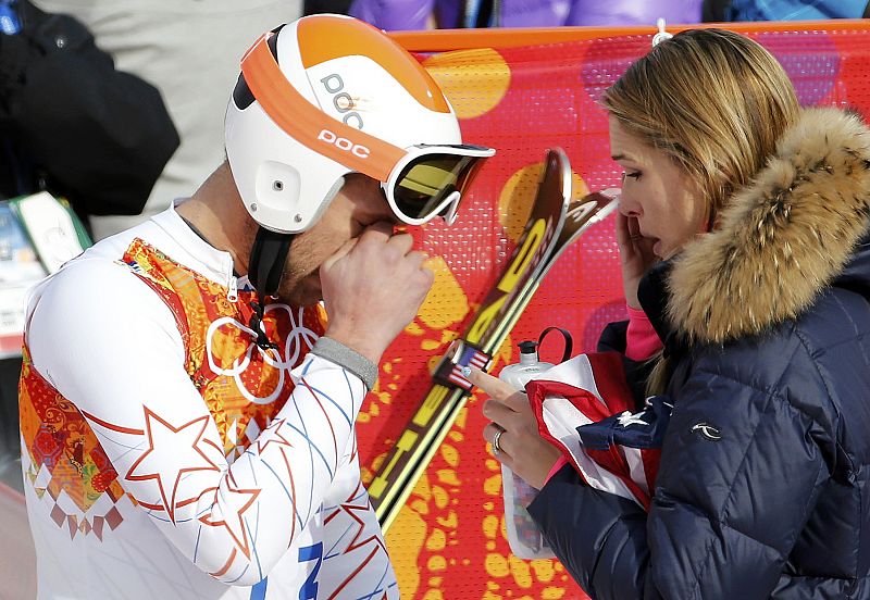 Bode Miller of the U.S. and his wife Morgan Beck cry in the mixed zone after finishing in the men's alpine skiing Super-G competition during the 2014 Sochi Winter Olympics at the Rosa Khutor Alpine Center