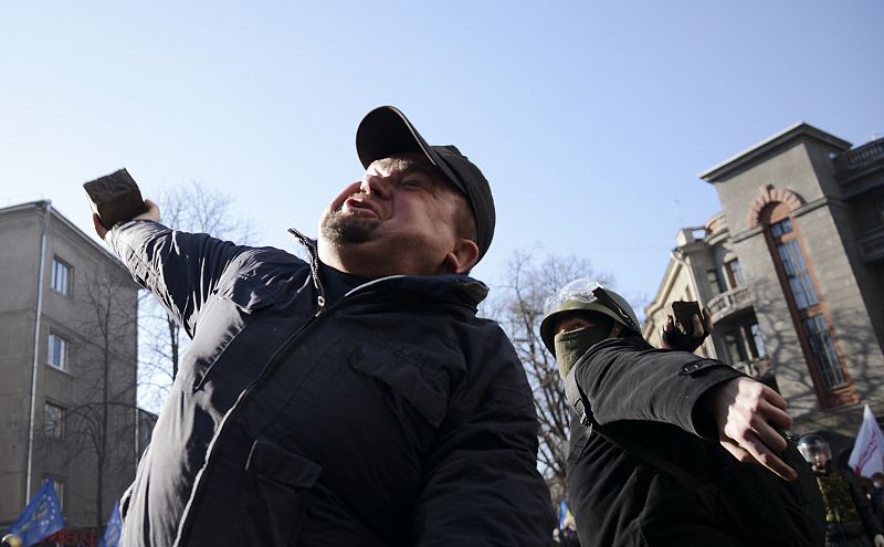 Manifestantes tiran piedras a la Policía cerca del edificio del Parlamento