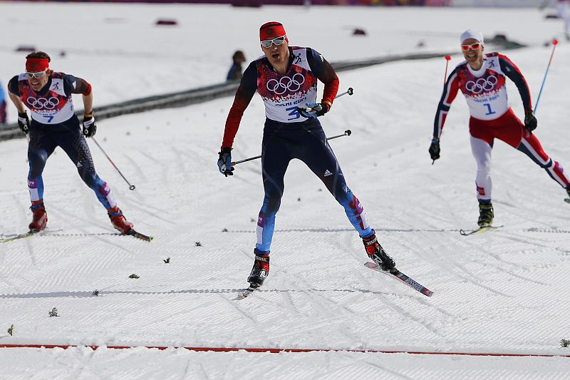 Russia's Legkov approaches the finish line ahead of his compatriot Vylegzhanin and Norway's Sundby during the men's cross-country 50 km mass start free event at the Sochi 2014 Winter Olympic Games in Rosa Khutor