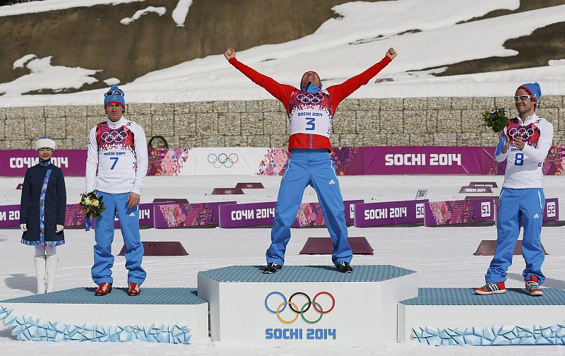 Russia's Vylegzhanin Legkov and Chernousov celebrate during flower ceremony for men's cross-country 50 km mass start free event at Sochi 2014 Winter Olympic Games