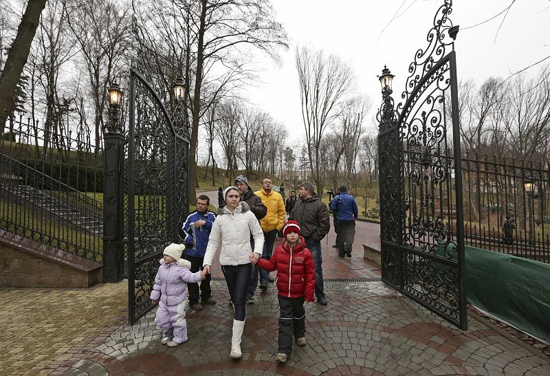 People walk on the grounds of the Mezhyhirya residence of Ukraine's President Viktor Yanukovich in the village Novi Petrivtsi outside Kiev