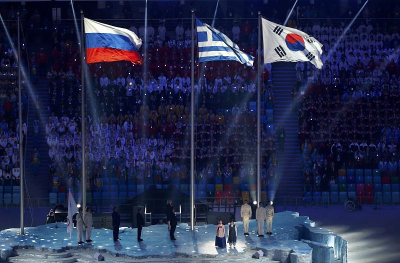 Flags of Russia, Greece and South Korea are raised during the closing ceremony for the 2014 Sochi Winter Olympics