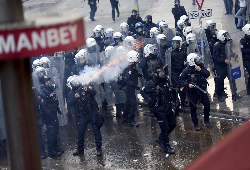 Riot police fires tear gas to push back thousands of demonstrators near Taksim square in Istanbul