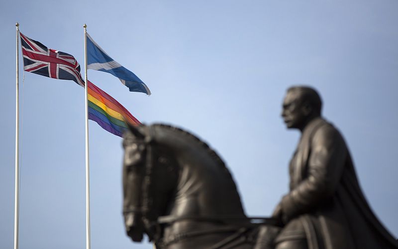 The rainbow flag flies with the Union Flag and the Scottish flag on Whitehall, marking the first day Britain has allowed same sex marriages, in London