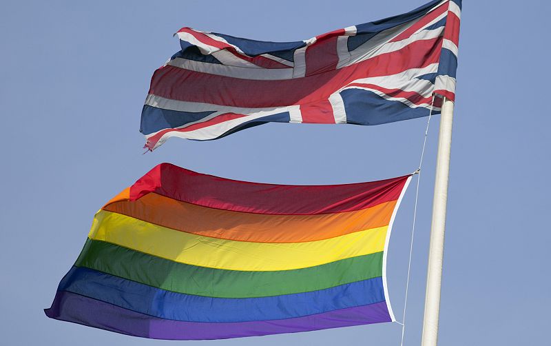 A rainbow flag flies with the Union flag above British Cabinet Offices, marking the first day Britain has allowed same sex marriages, in London