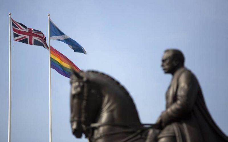 The rainbow flag flies with the Union Flag and the Scottish flag on Whitehall, marking the first day Britain has allowed same sex marriages, in London