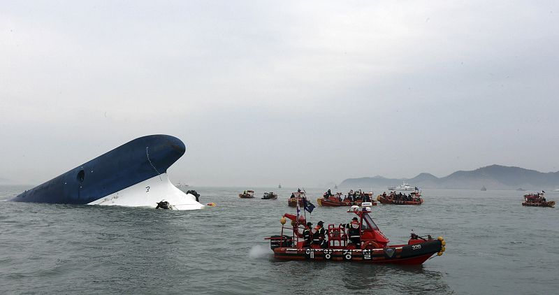 Part of South Korean passenger ship "Sewol" that has been sinking is seen as South Korean maritime policemen search for passengers in the sea off Jindo