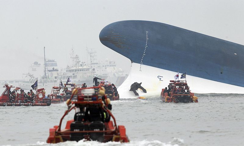 Part of South Korean passenger ship "Sewol" that has been sinking is seen as South Korean maritime policemen search for passengers in the sea off Jindo