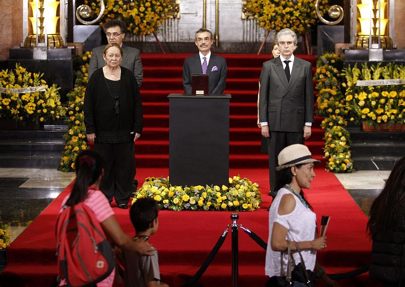 Mercedes Barcha and her sons Rodrigo Garcia Barcha and Gonzalo Garcia Barcha stand next to an urn containing Garcia Marquez' ashes for public viewing in the Palace of Fine Arts in Mexico City