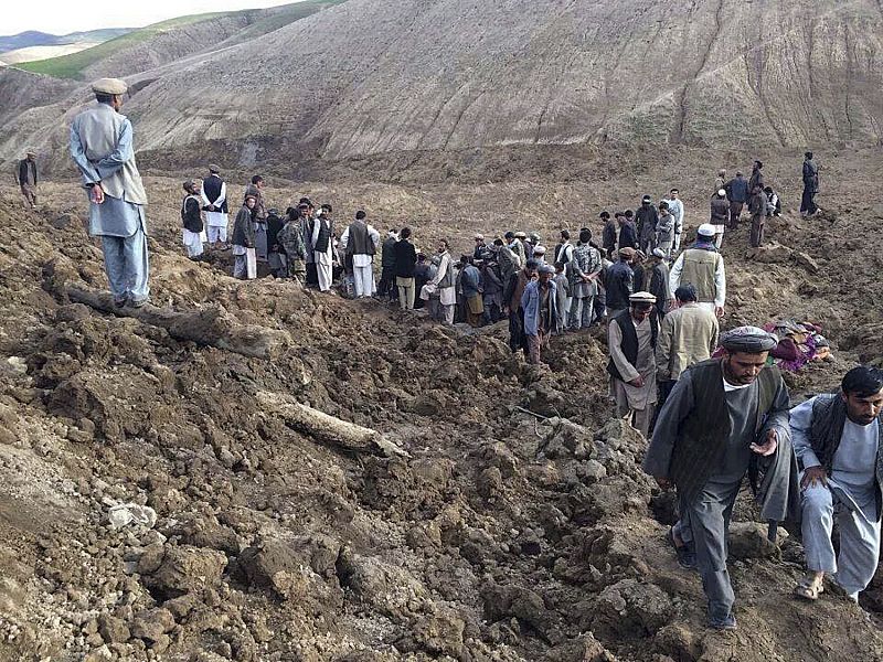 Afghan villagers gather at the site of a landslide at the Argo district in Badakhshan