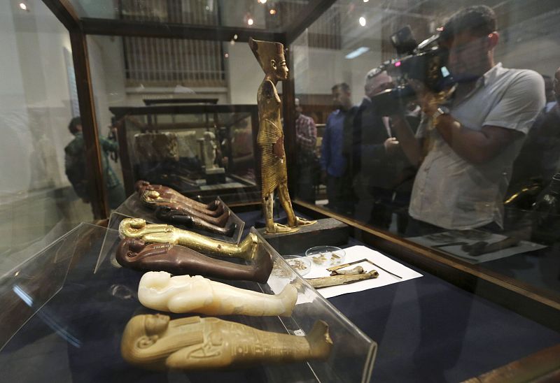 A videographer videos artefacts on display during the inauguration of an exhibition of repatriated historical objects at the Egyptian Museum in Cairo