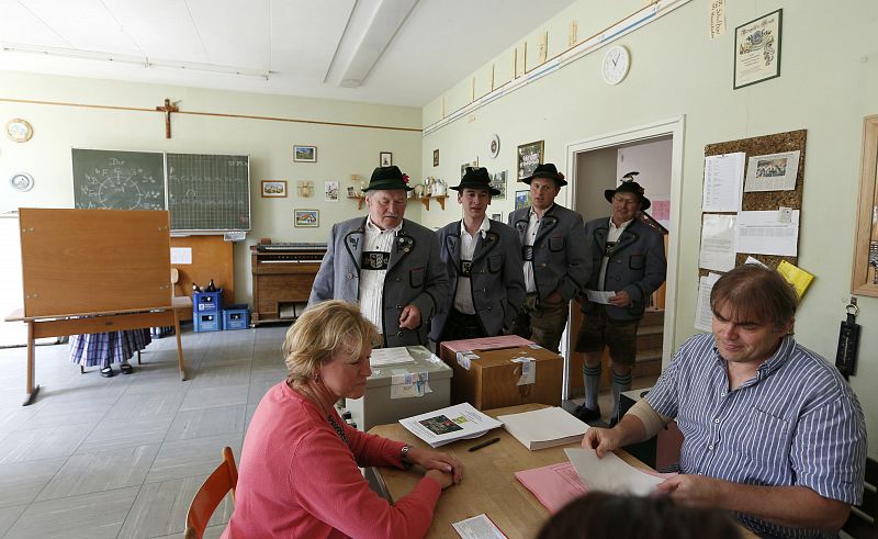 People in traditional clothes prepare to vote in the European Parliament elections in Haunshofen